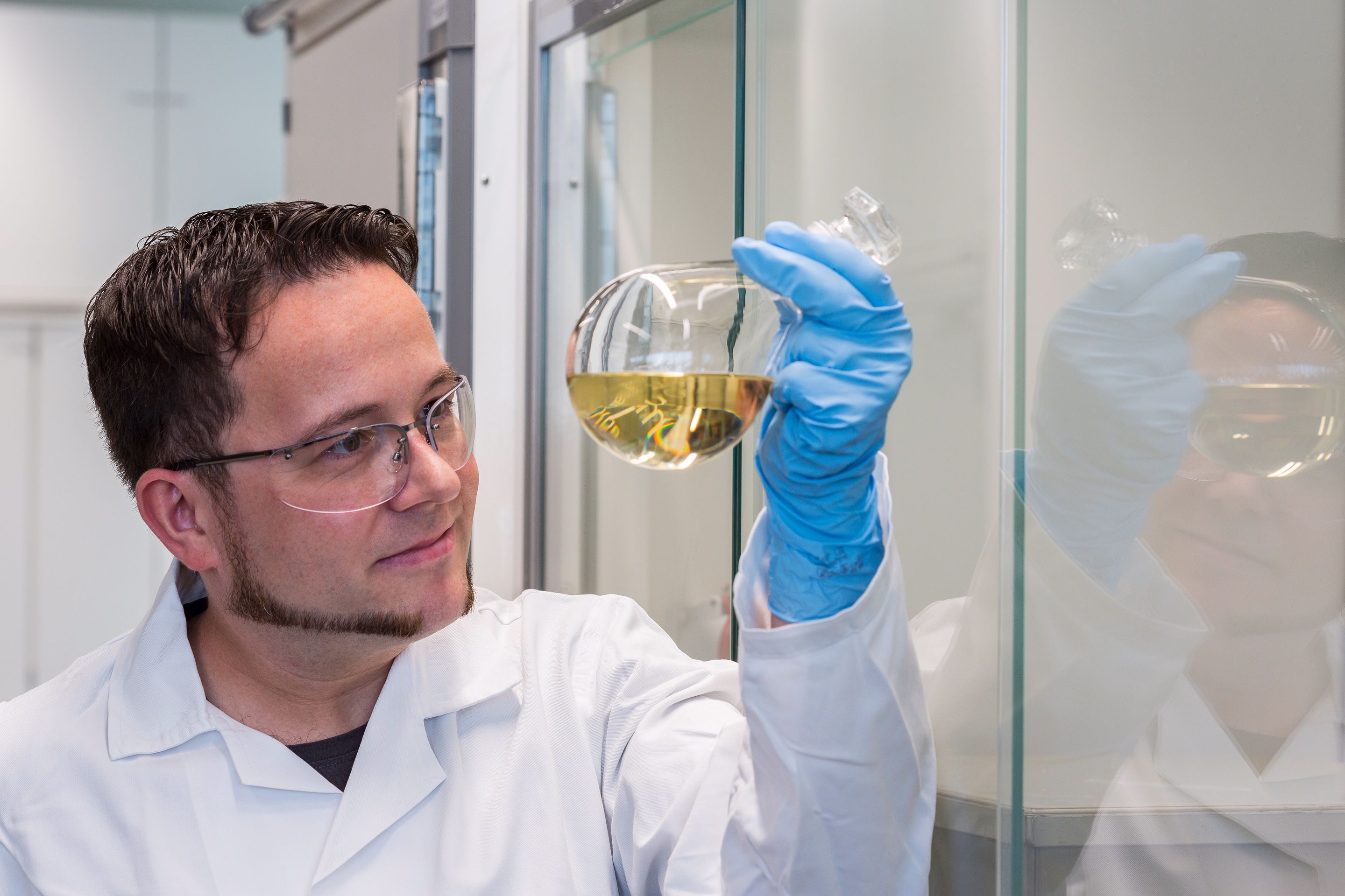 Man with flask filled with chemical substances