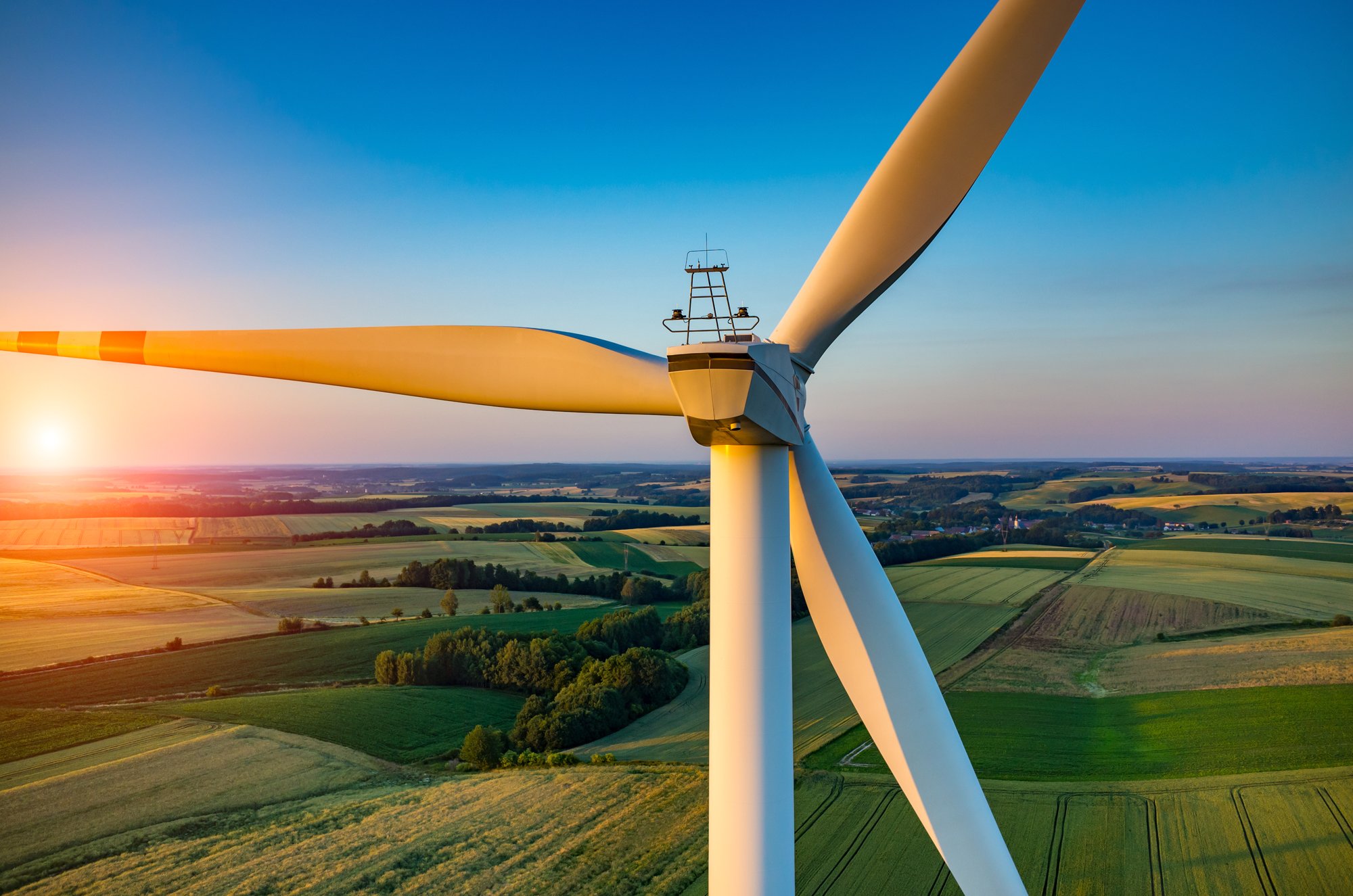 Beautiful sunset above a wind turbine on a field